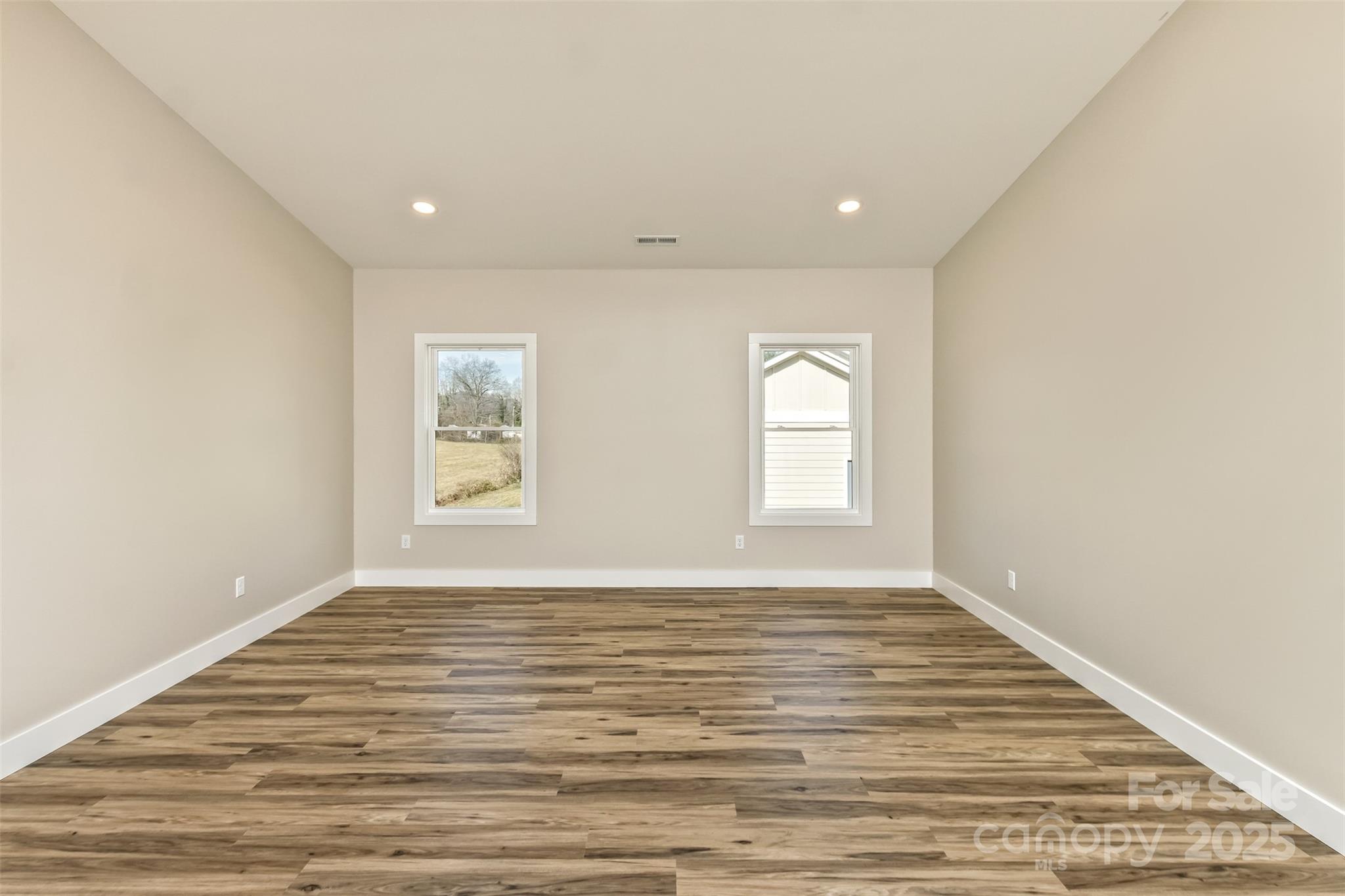 115 Peyton Elaine Road Clyde, NC 28721 - Photo 12 of 37 a view of an empty room with wooden floor and a window