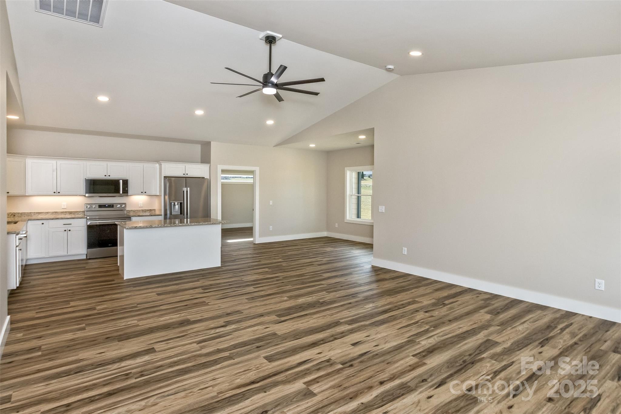115 Peyton Elaine Road Clyde, NC 28721 - Photo 14 of 37 a view of a kitchen with a stove cabinets and wooden floor