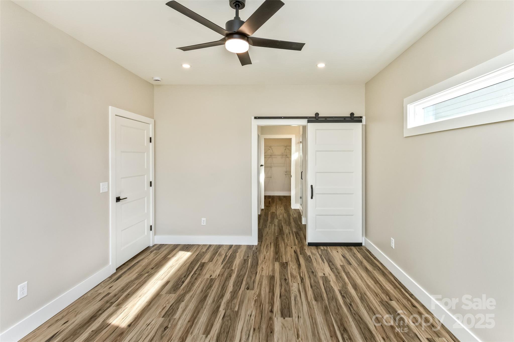 115 Peyton Elaine Road Clyde, NC 28721 - Photo 16 of 37 a view of a room with wooden floor a ceiling fan and closet