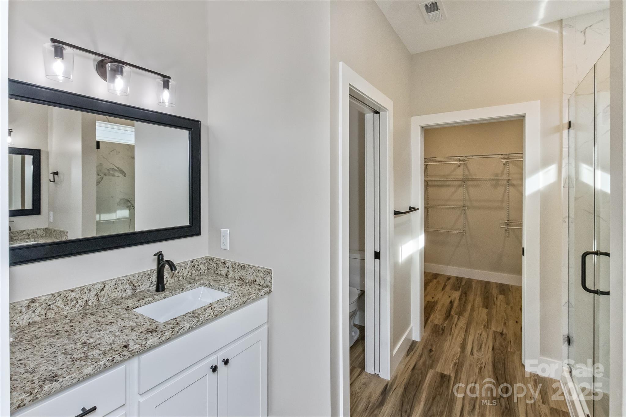 115 Peyton Elaine Road Clyde, NC 28721 - Photo 19 of 37 a bathroom with a granite countertop sink and a mirror