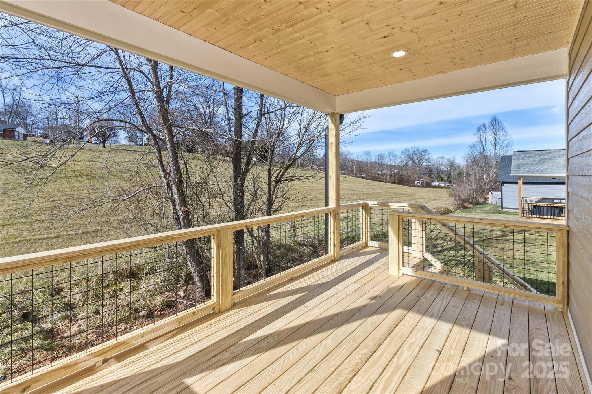 115 Peyton Elaine Road Clyde, NC 28721 - Photo 33 of 37 a view of balcony with floor to ceiling windows with wooden floor