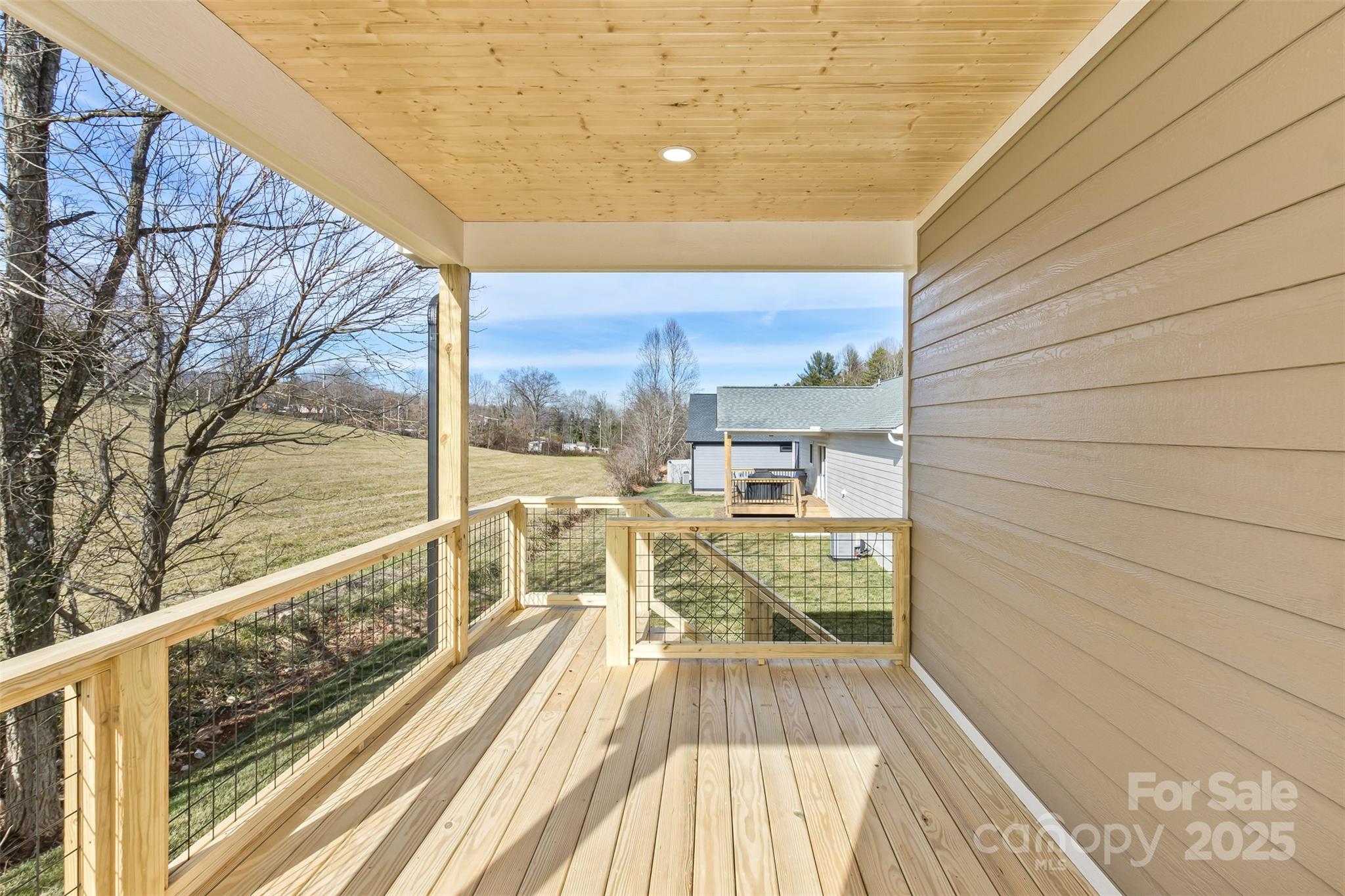 115 Peyton Elaine Road Clyde, NC 28721 - Photo 34 of 37 a view of balcony with a large window and wooden floor