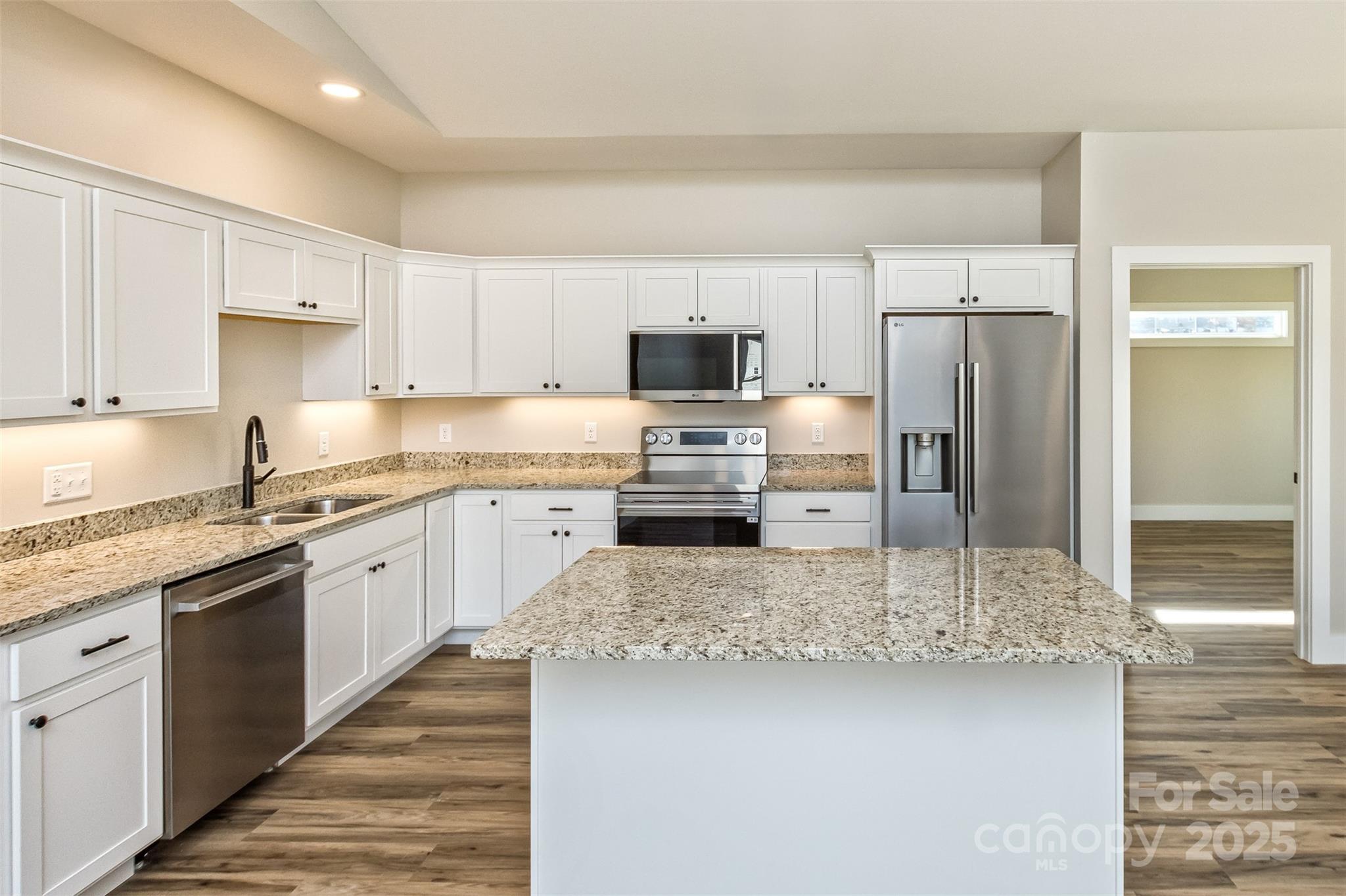 115 Peyton Elaine Road Clyde, NC 28721 - Photo 9 of 37 a kitchen with granite countertop a refrigerator sink and cabinets