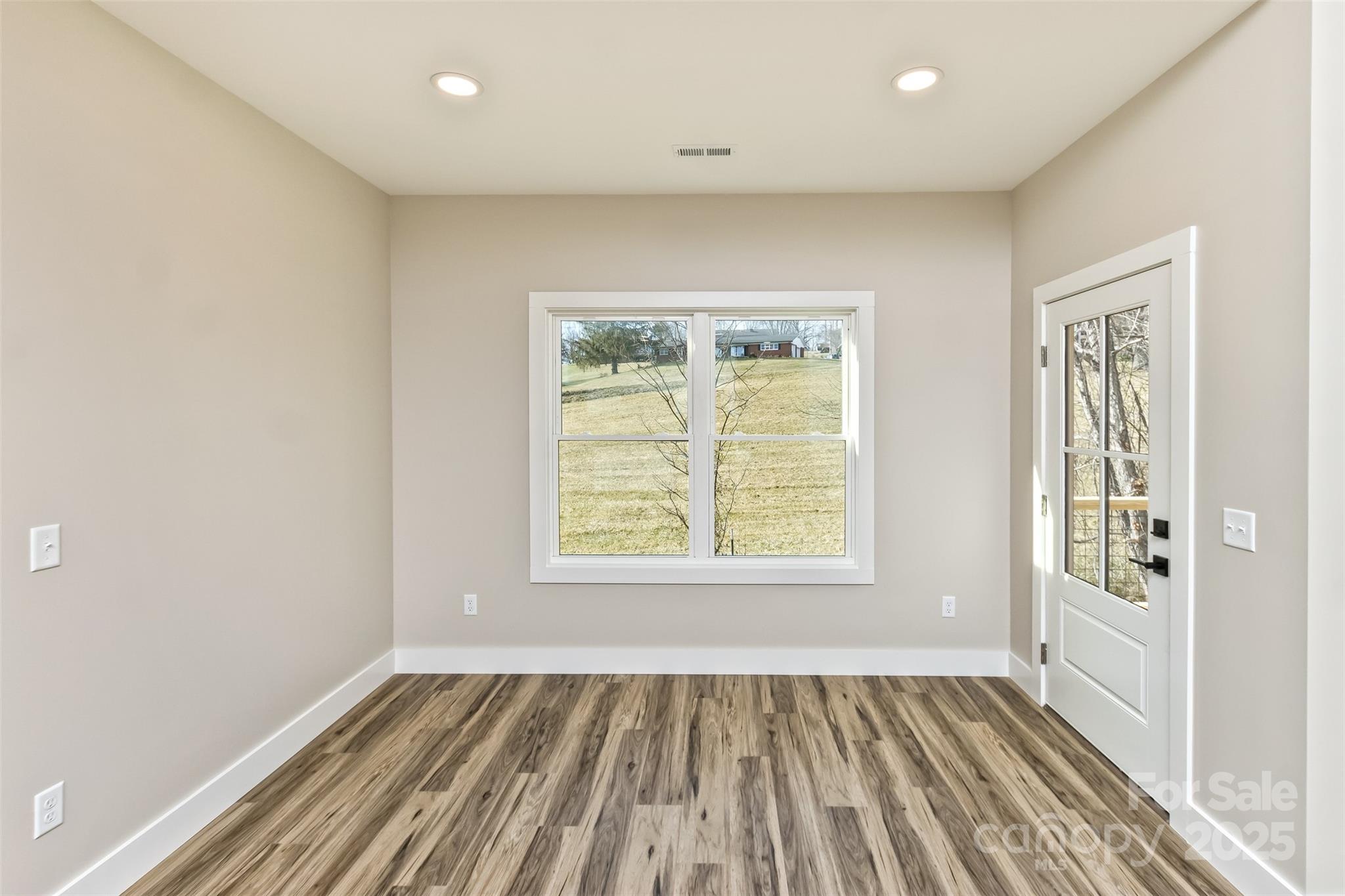 115 Peyton Elaine Road Clyde, NC 28721 - Photo 10 of 37 an empty room with wooden floor and windows