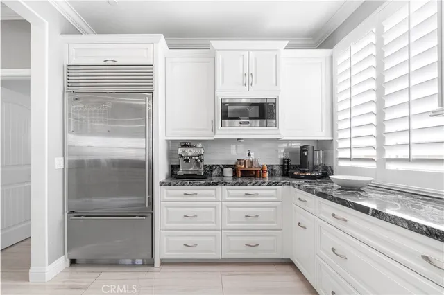 a bed room with a bed a television and dresser