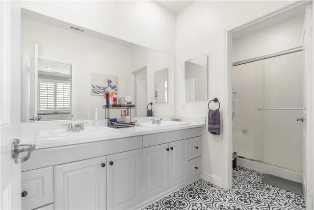 a view of a living room and kitchen with furniture wooden floor and windows