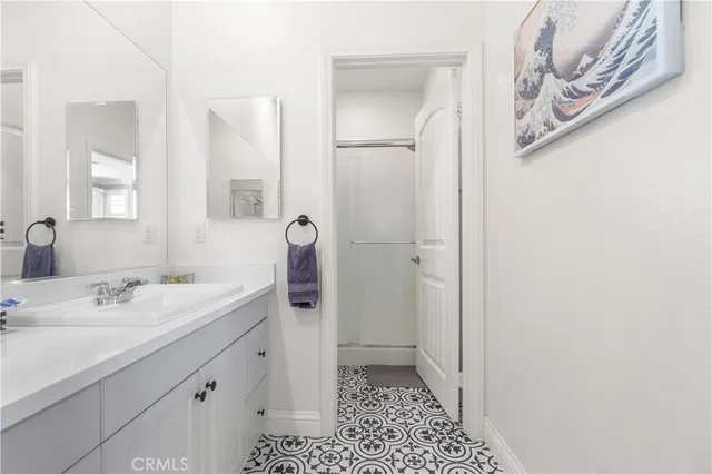 a large living room with stainless steel appliances kitchen island granite countertop wooden floor a large window and a couch