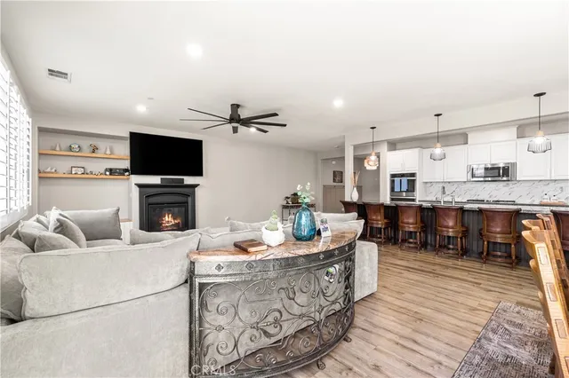 a bathroom with double vanity sink a mirror a bathtub and a window
