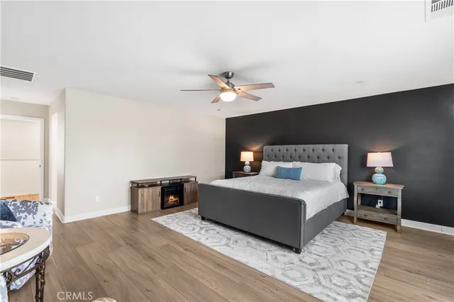 a bedroom with furniture and a ceiling fan