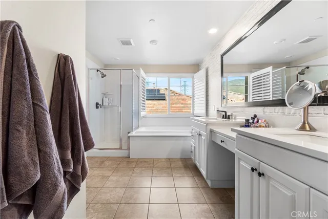 a view of a patio with couches table and chairs under an umbrella
