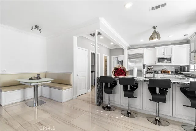 a kitchen with stainless steel appliances kitchen island granite countertop a stove and a refrigerator