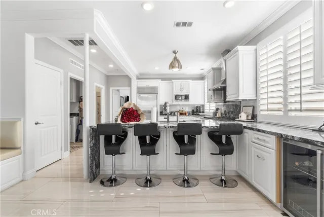a kitchen with white cabinets and white appliances