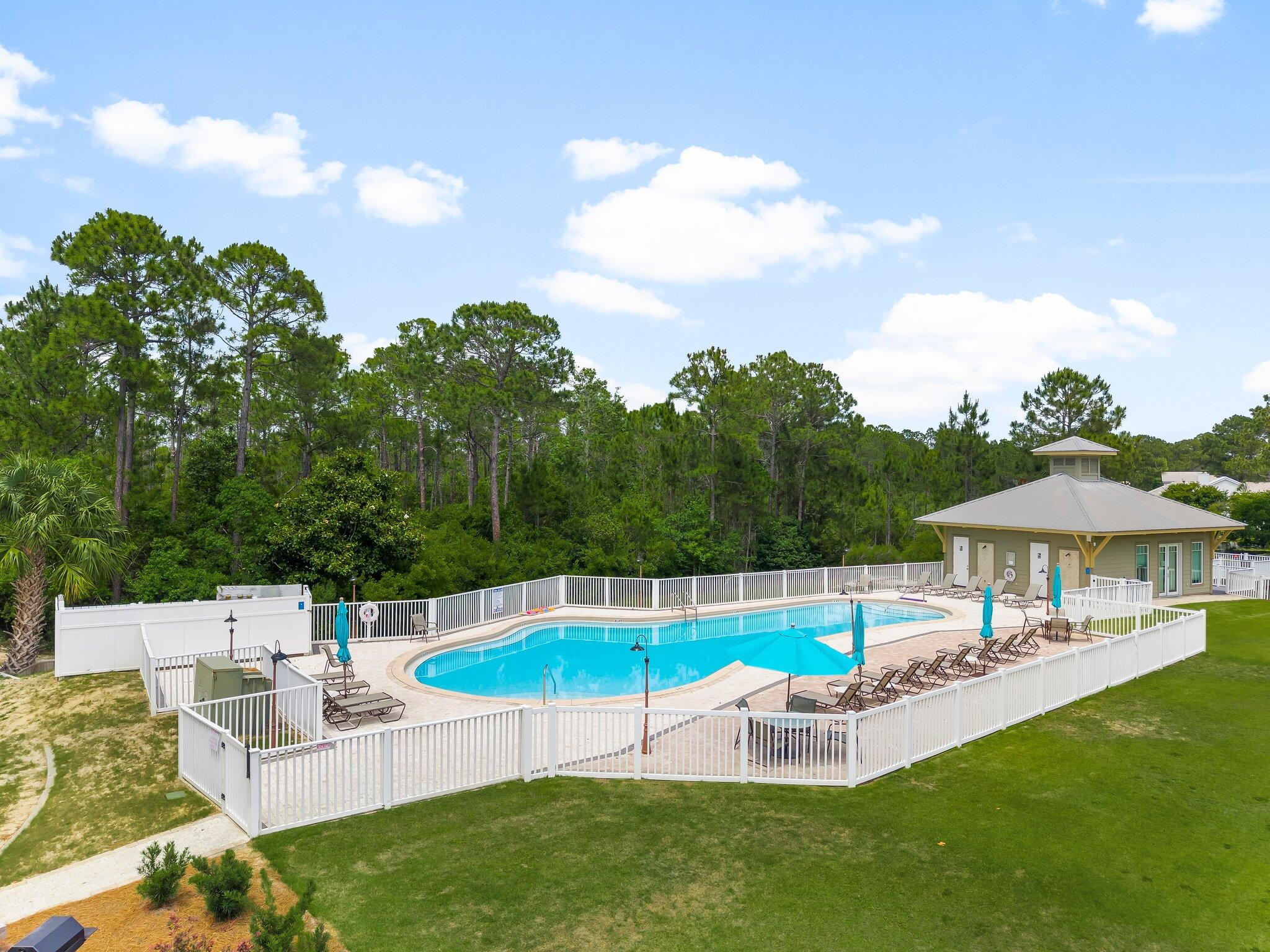 231 Somerset Bridge Road, Unit 2209 Santa Rosa Beach, FL 32459 - Photo 27 of 30 a view of a swimming pool with lawn chairs under an umbrella