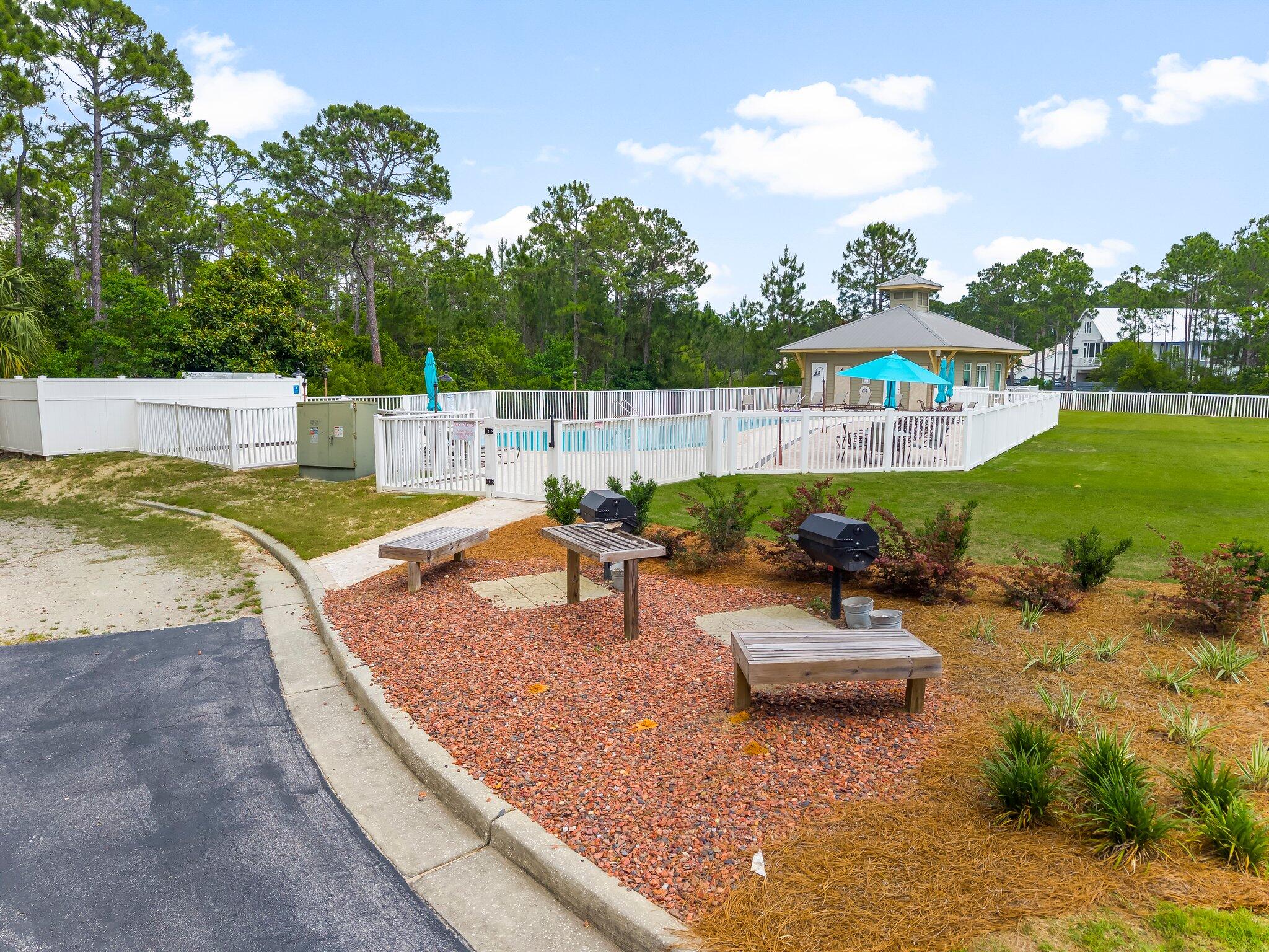 231 Somerset Bridge Road, Unit 2209 Santa Rosa Beach, FL 32459 - Photo 28 of 30 a view of a patio with a table and chairs
