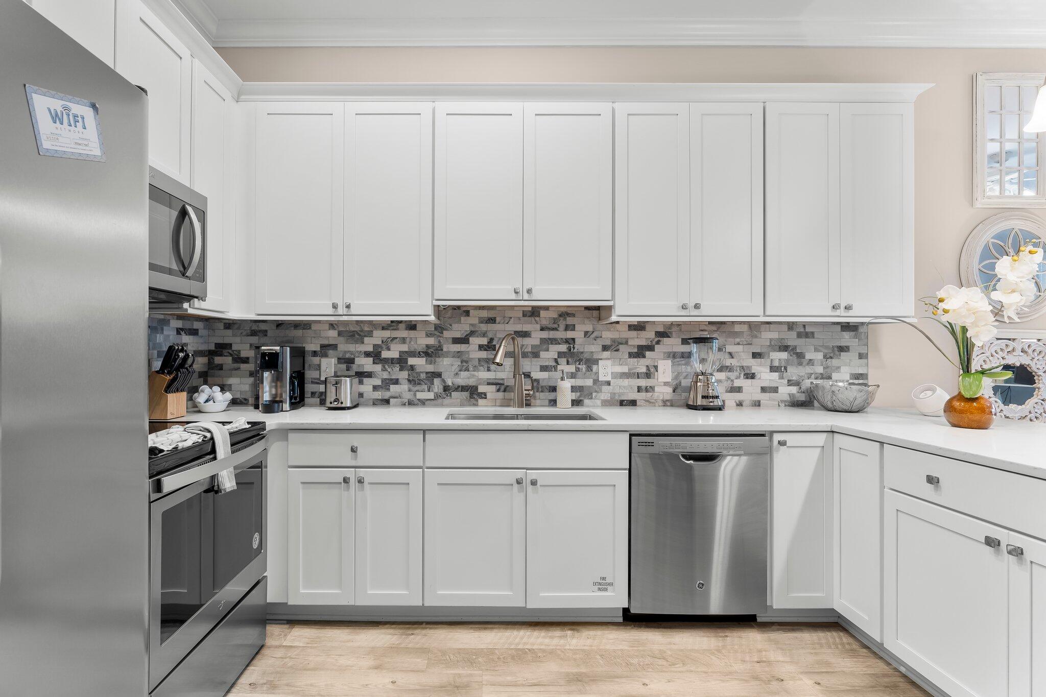 231 Somerset Bridge Road, Unit 2209 Santa Rosa Beach, FL 32459 - Photo 6 of 30 a kitchen with white cabinets sink and white stainless steel appliances