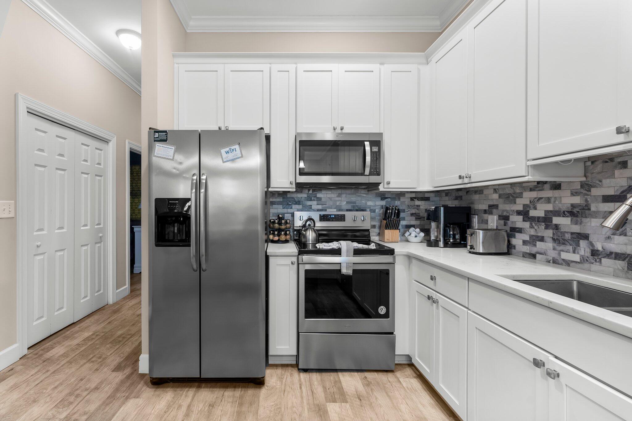 231 Somerset Bridge Road, Unit 2209 Santa Rosa Beach, FL 32459 - Photo 7 of 30 a kitchen with stainless steel appliances granite countertop a refrigerator sink and stove