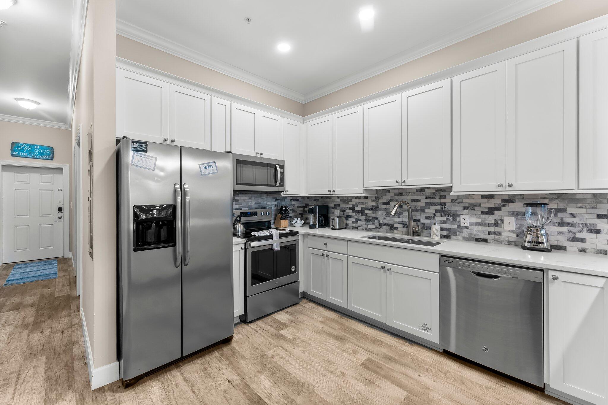 231 Somerset Bridge Road, Unit 2209 Santa Rosa Beach, FL 32459 - Photo 8 of 30 a kitchen with granite countertop white cabinets and stainless steel appliances