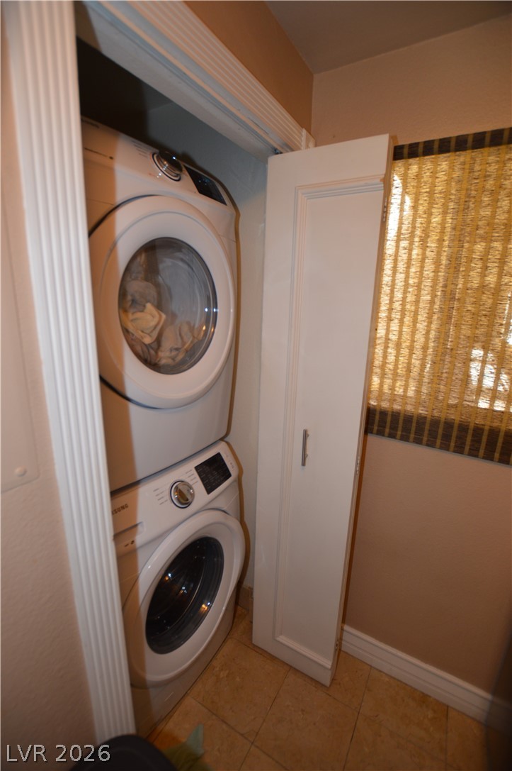 220 East Flamingo Road, Unit 327 Las Vegas, NV 89169 - Photo 6 of 13 A compact laundry space features stacked appliances, offering efficient utility.