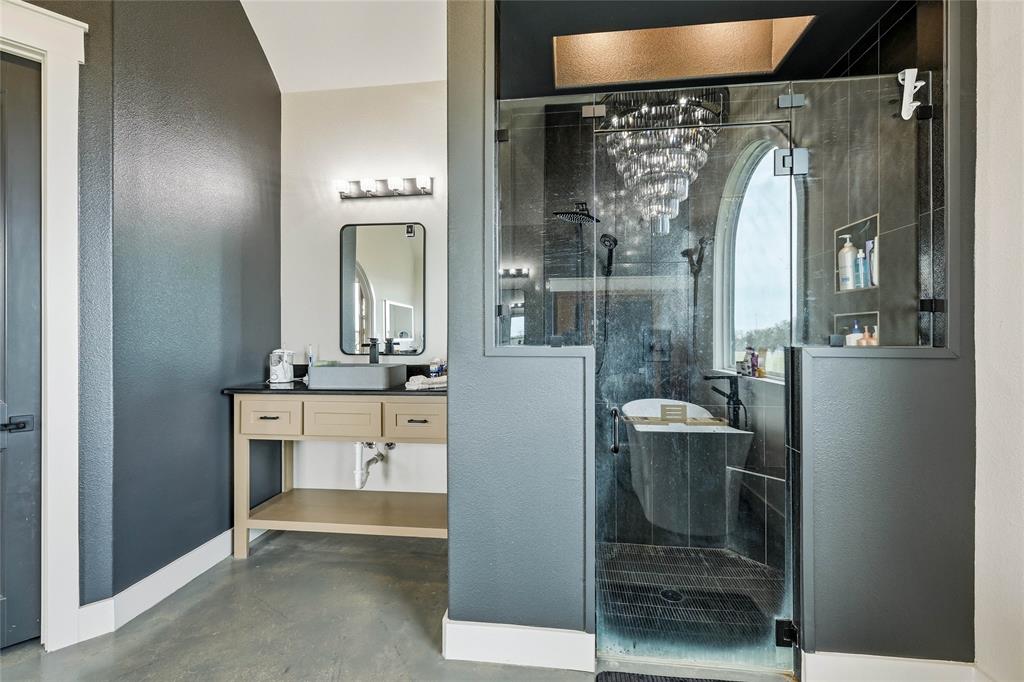 3988 Lake Valley Road Sunset, TX 76270 - Photo 17 of 39 a bathroom with a sink a mirror and a shower