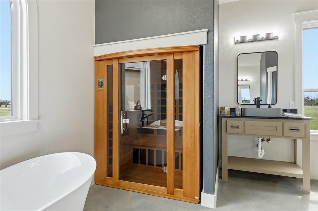 3988 Lake Valley Road Sunset, TX 76270 - Photo 21 of 39 a bathroom with a tub and a sink