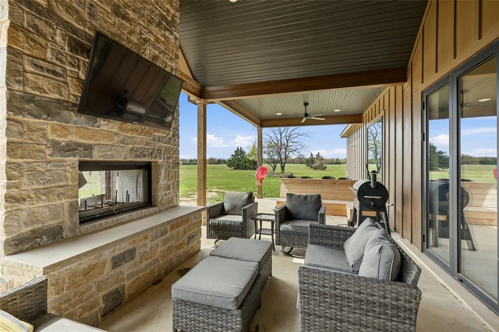 3988 Lake Valley Road Sunset, TX 76270 - Photo 30 of 39 a living room with furniture fireplace and a flat screen tv