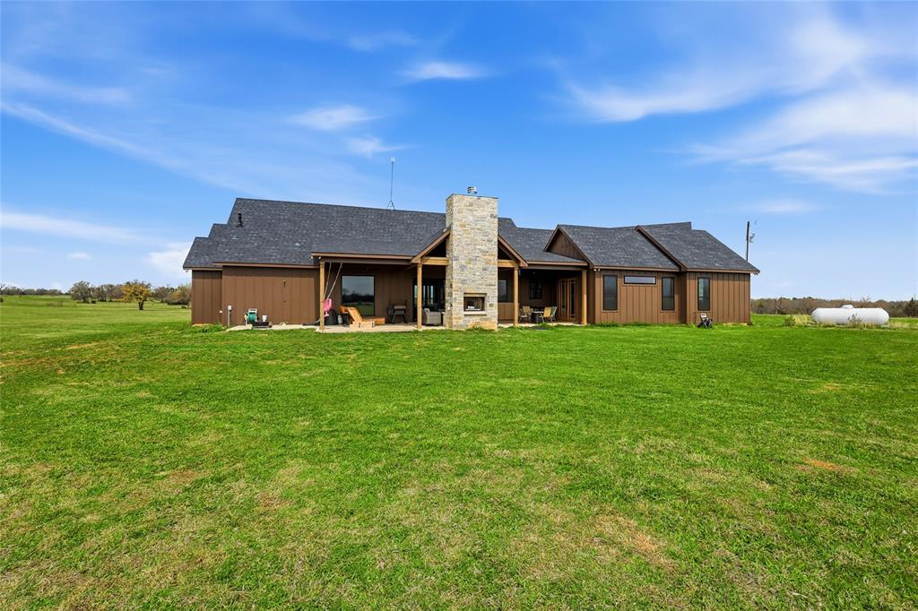 3988 Lake Valley Road Sunset, TX 76270 - Photo 31 of 39 a front view of house with a garden