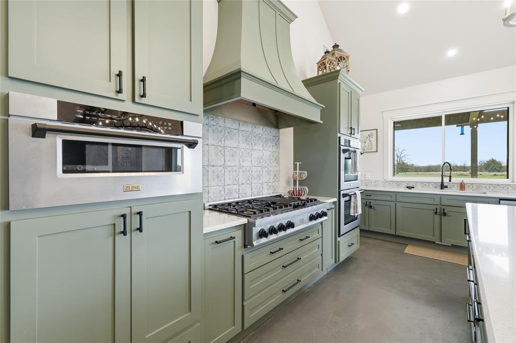 3988 Lake Valley Road Sunset, TX 76270 - Photo 9 of 39 a kitchen with a stove and a sink