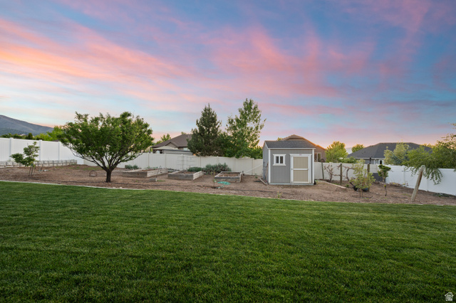 1145 North Christley Lane, Unit 48 Elk Ridge, UT 84651 - Photo 34 of 38 Vegetable garden with fruit trees.