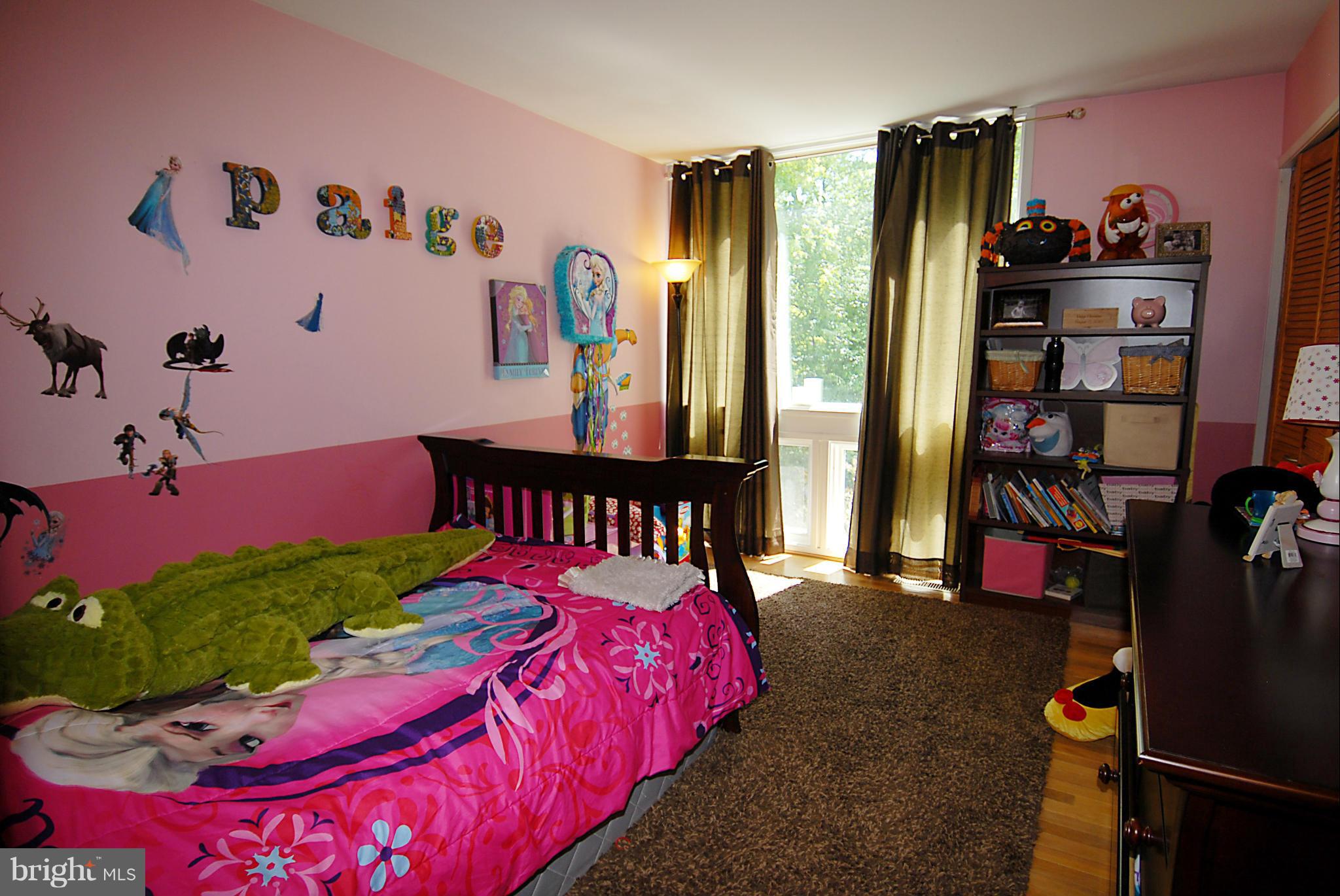 11502 Hickory Cluster Reston, VA 20190 - Photo 14 of 29 a bed room with a bed and a book shelf