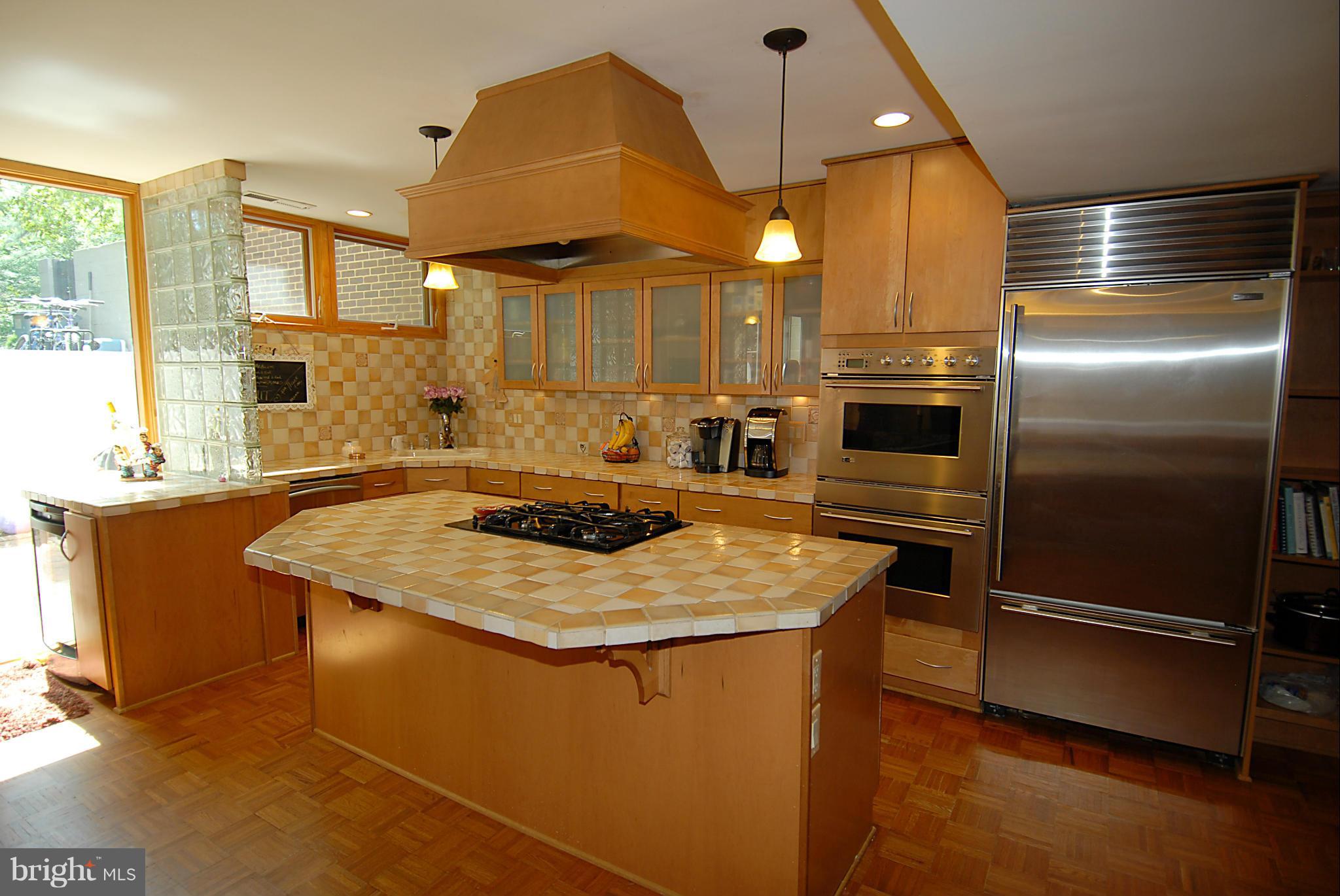 11502 Hickory Cluster Reston, VA 20190 - Photo 3 of 29 a kitchen with stainless steel appliances granite countertop a sink a refrigerator and a stove