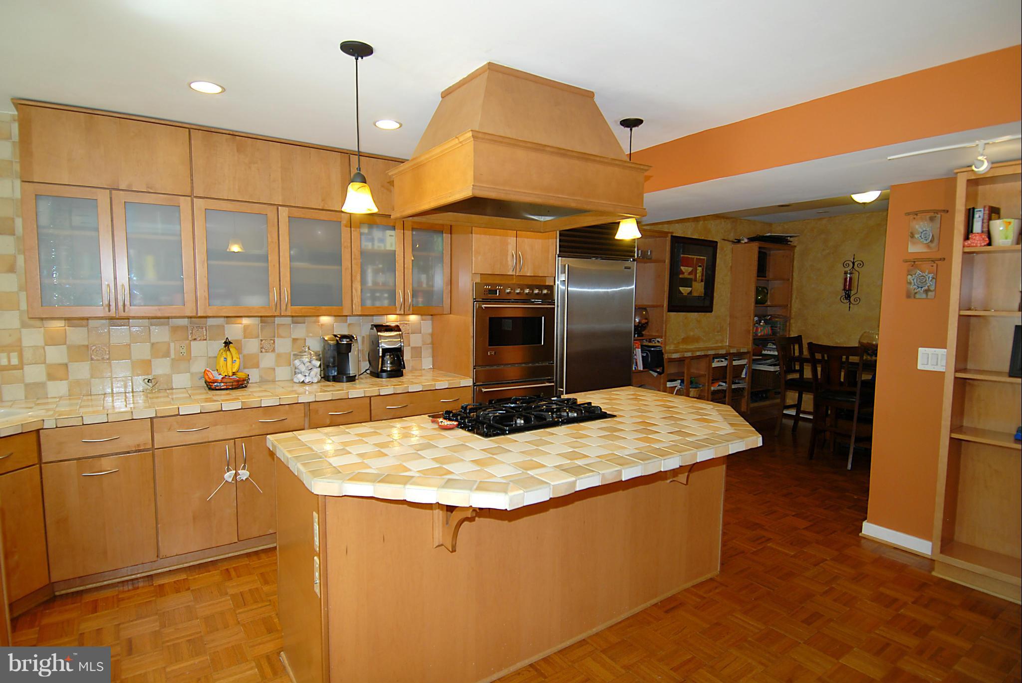 11502 Hickory Cluster Reston, VA 20190 - Photo 5 of 29 a kitchen with kitchen island granite countertop a sink counter top space cabinets and stainless steel appliances