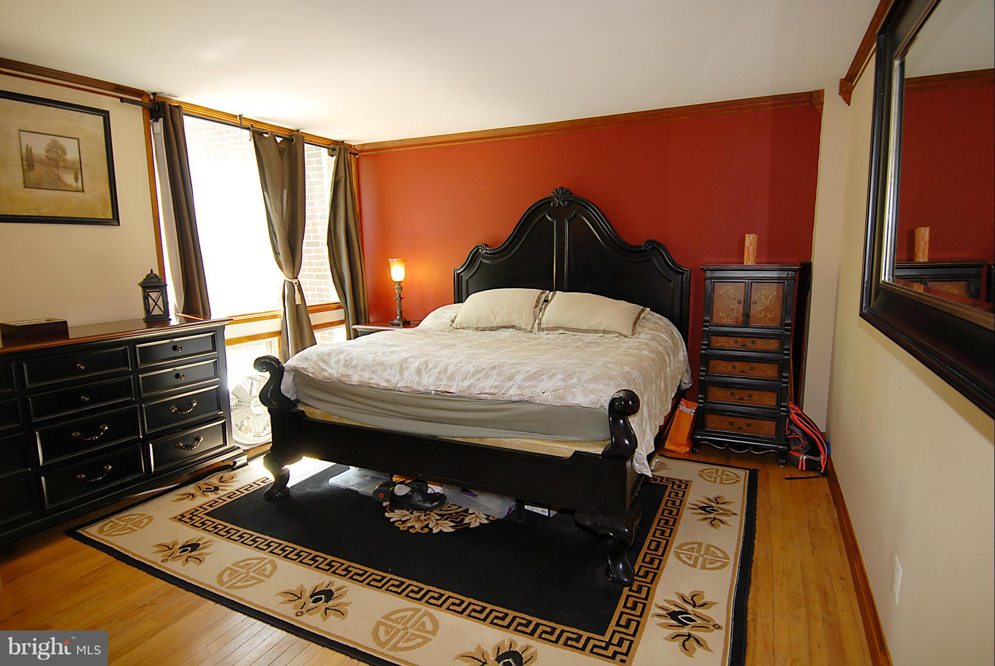 11502 Hickory Cluster Reston, VA 20190 - Photo 8 of 29 a bedroom with a bed and wooden floor
