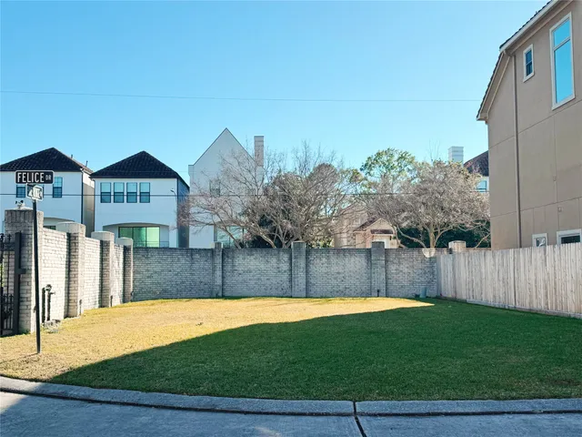 a view of a brick house with a swimming pool in front of it