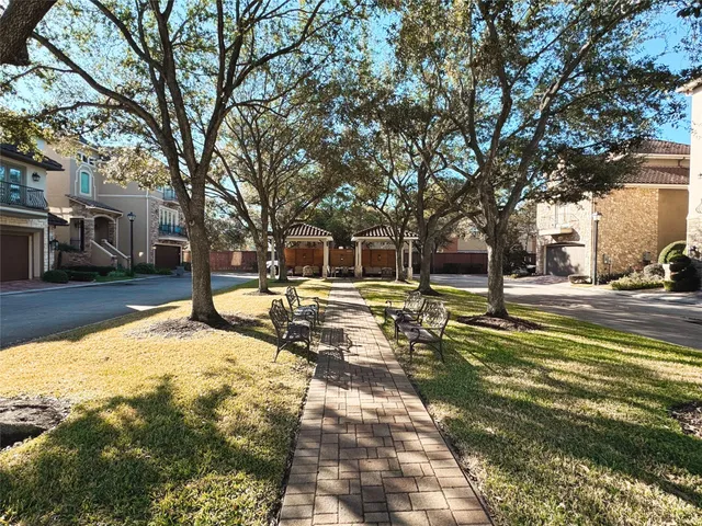 a view of yard with swimming pool and trees