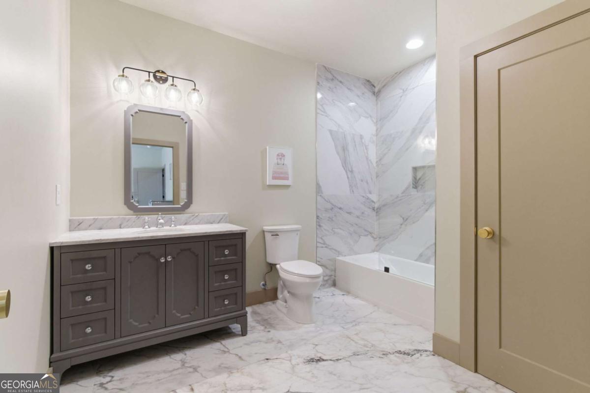 1315 Sandy Creek Road Tyrone, GA 30290 - Photo 87 of 100 a bathroom with a granite countertop sink a toilet and a mirror
