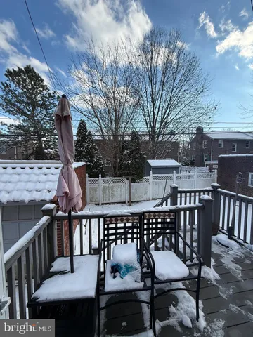 a view of a balcony with wooden floor and outdoor seating