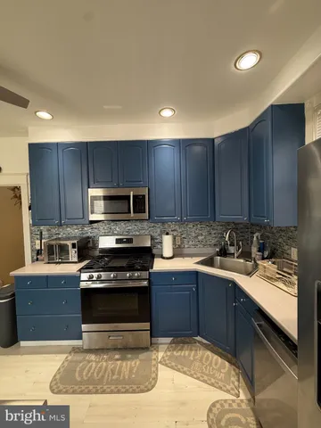 a kitchen with wooden cabinets and stainless steel appliances