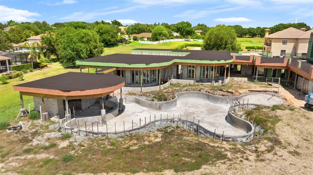 9621 Windy Ridge Road Windermere, FL 34786 - Photo 3 of 28 a view of a patio with swimming pool and mountain view