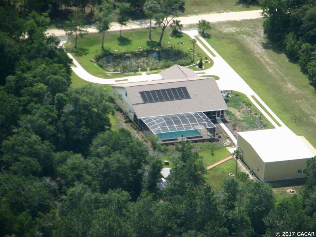 6890 Southwest 103rd Terrace Cedar Key, FL 32625 - Photo 1 of 1 an aerial view of house with yard