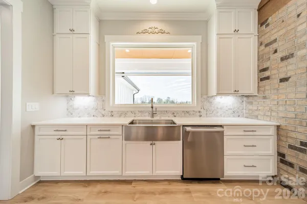 a kitchen with stainless steel appliances granite countertop a sink and a window