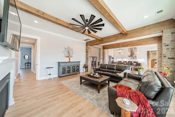 a living room with furniture a fireplace and a large window