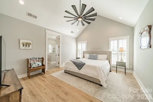 a bedroom with a bed and a chandelier