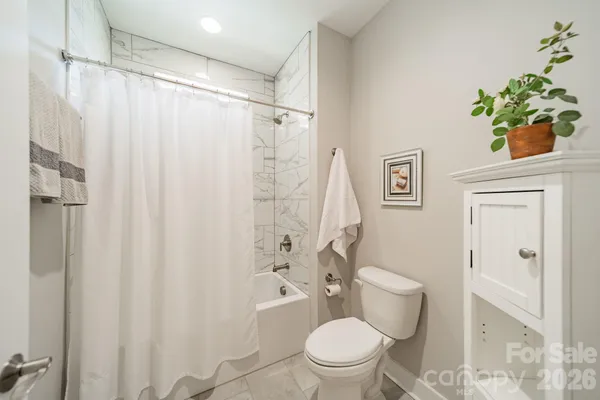 a white toilet sitting next to a bathroom sink