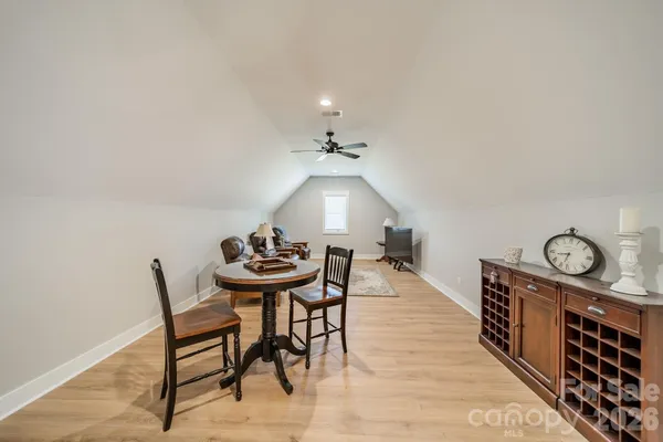 a dining room with furniture and a chandelier