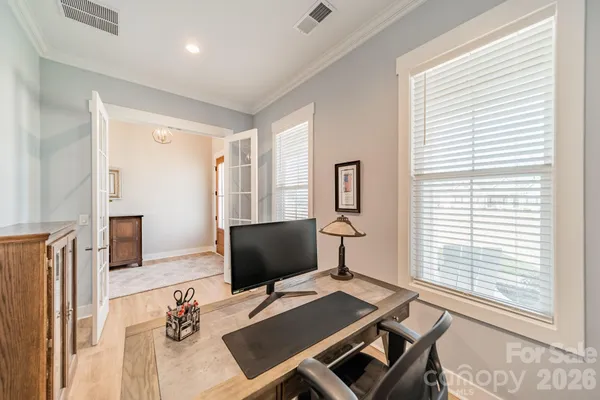 a view of a workspace with furniture and a window