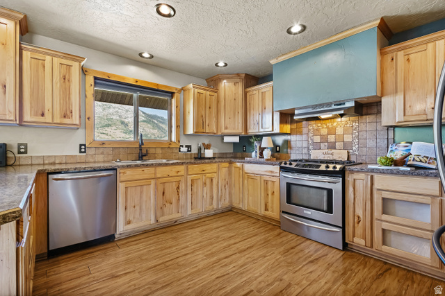 2013 North River View Road Huntsville, UT 84317 - Photo 13 of 53 Kitchen with stainless steel appliances, recessed lighting, light wood finish cabinetry, light wood-type flooring, and a textured ceiling