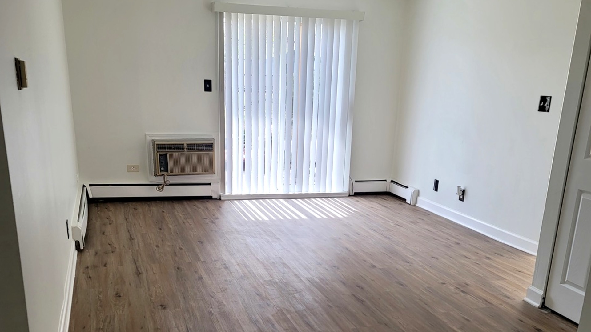 2700 Light Road, Unit 110 Oswego, IL 60543 - Photo 2 of 12 a view of a livingroom with wooden floor