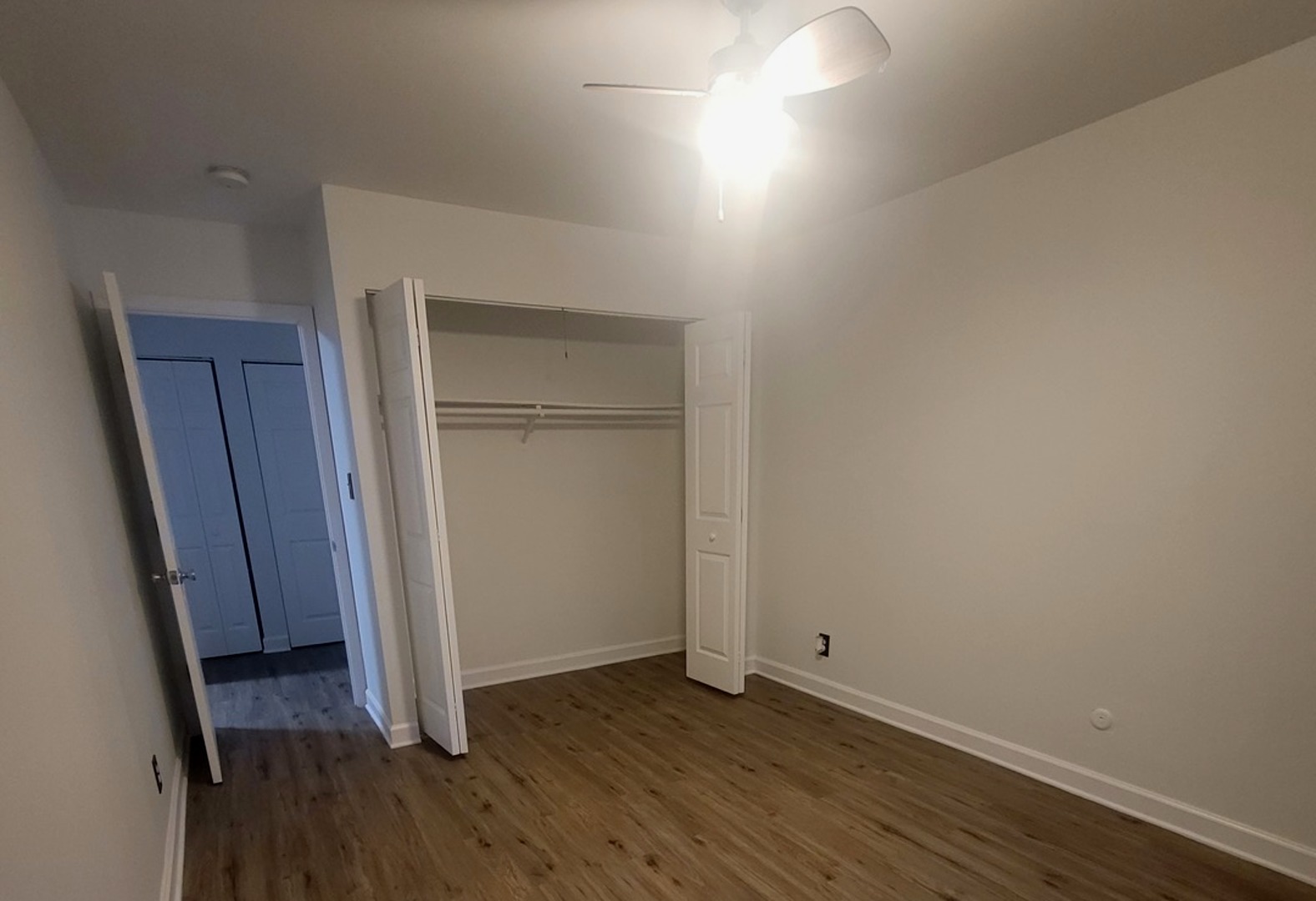 2700 Light Road, Unit 110 Oswego, IL 60543 - Photo 4 of 12 a view of an empty room with wooden floor