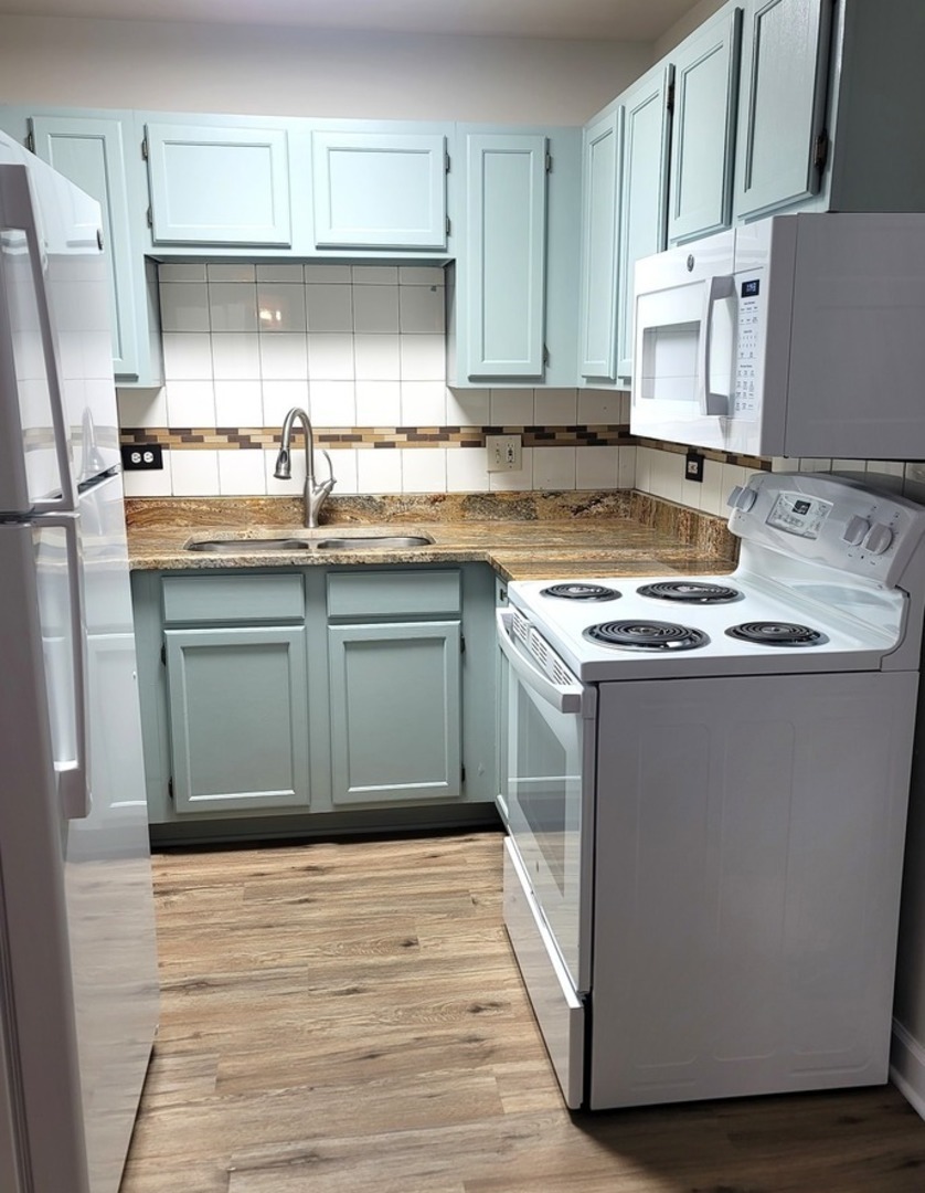 2700 Light Road, Unit 110 Oswego, IL 60543 - Photo 9 of 12 a kitchen with stainless steel appliances granite countertop a sink stove and refrigerator