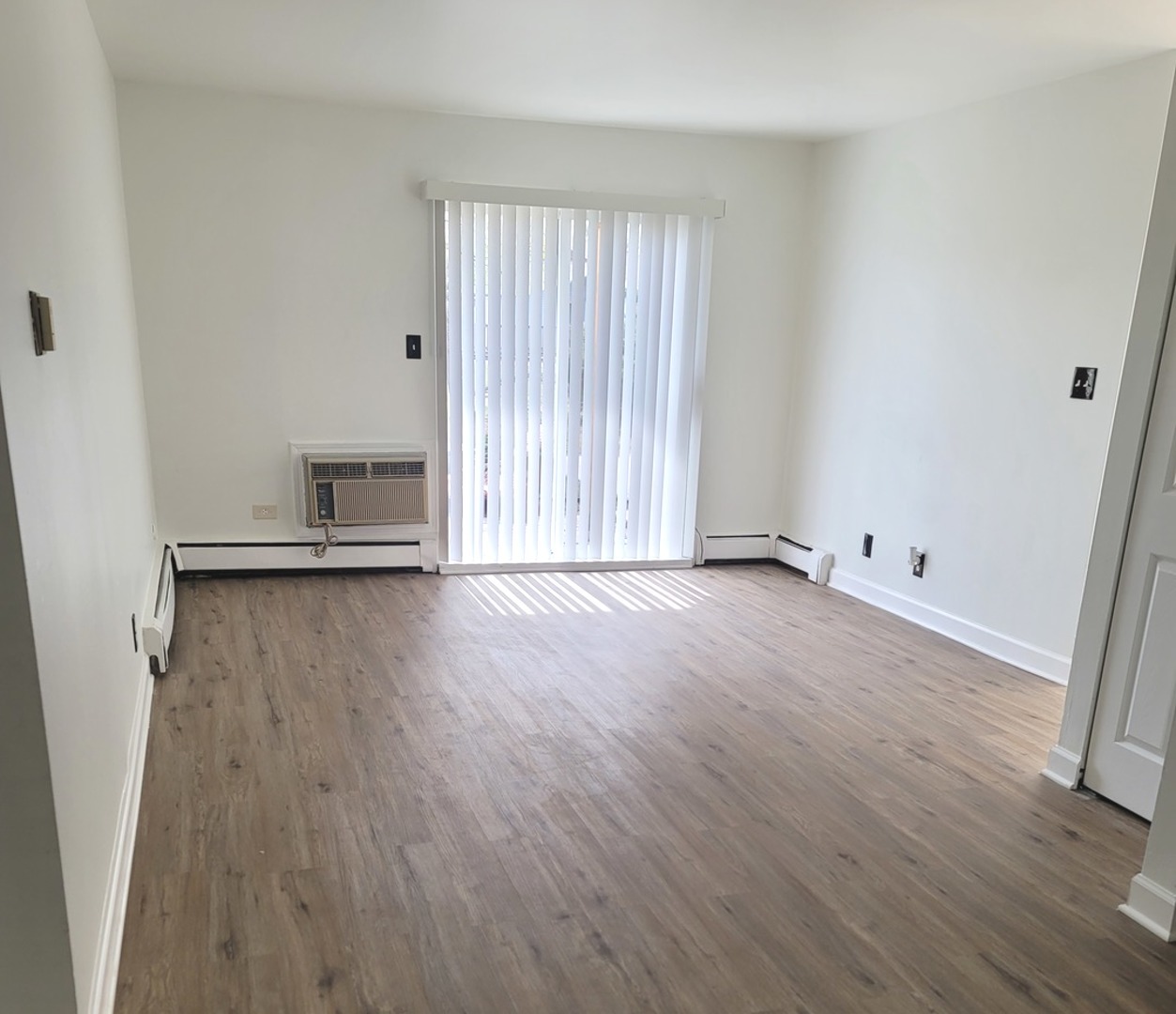 2700 Light Road, Unit 110 Oswego, IL 60543 - Photo 10 of 12 an empty room with wooden floor and windows